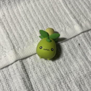 This complex object is an eraser of the Pokemon Smoliv. I bought this with my little sister and really enjoy collecting Pokemon trinkets with her so it makes me happy to see my Pokemon collection.